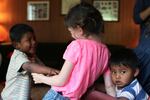 Three of Carla and Rudi Booher's children play in their home.