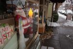 A Santa Claus statue looks out the window of Sellwood Unique Antique at a snowy 13th Avenue in the Sellwood neighborhood during a snowstorm in Portland, on Thursday, Dec. 8, 2016.