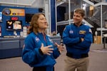 Astronaut Reid Wiseman, Artemis II commander, right, listens as his colleague Christina Koch, who is also an astronaut and Artemis II mission specialist, talks on Aug. 26, 2024, at the NASA Johnson Space Center in Houston, Texas.