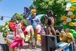 Drag queen and cast member of Darcelle XV Showplace BinKyee Bellflower, center, stands on a float with other members of the cast in the Portland Pride parade as they move through the streets of downtown Portland, Ore., on July 19, 2026.