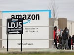 Workers walk toward an Amazon warehouse on Staten Island, New York, on April 25, 2022. It's the second Amazon facility on Staten Island to vote on whether to join the Amazon Labor Union.