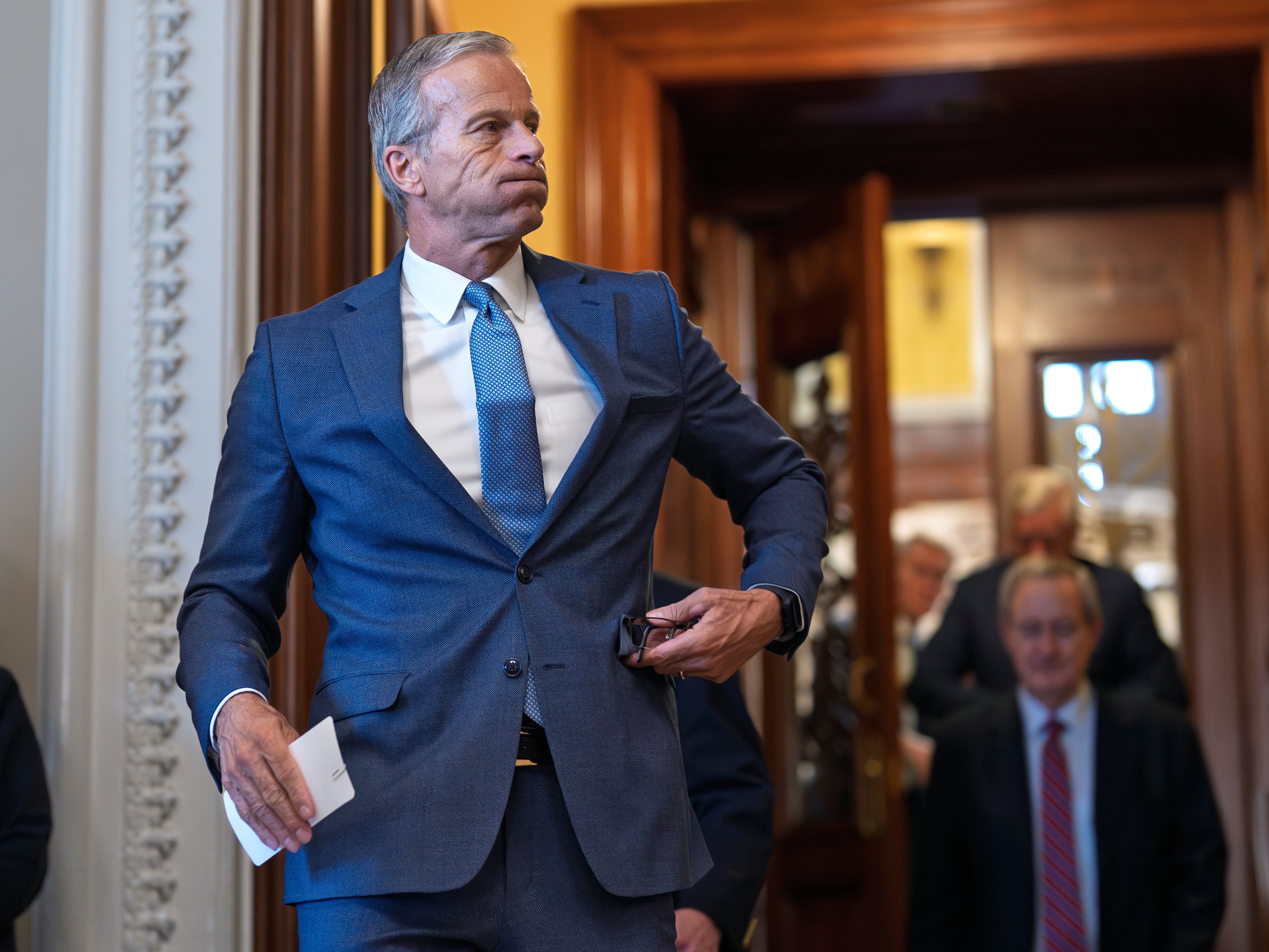 Senate Majority Leader John Thune, R-S.D., emerges from the chamber just after passage of the budget reconciliation package of President Donald Trump's signature bill of big tax breaks and spending cuts, at the Capitol in Washington, Tuesday, July 1, 2025.