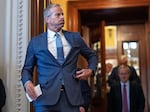 Senate Majority Leader John Thune, R-S.D., emerges from the chamber just after passage of the budget reconciliation package of President Donald Trump's signature bill of big tax breaks and spending cuts, at the Capitol in Washington, Tuesday, July 1, 2025. 