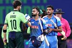 India's Virat Kohli and Axar Patel shake hands with Pakistan's Shaheen Shah Afridi (left) at the end of the ICC Champions Trophy one-day international cricket match between Pakistan and India at the Dubai International Stadium on Feb. 23.