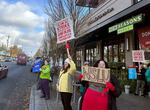 Unionized employees on strike outside the Woodstock New Seasons Market in Southeast Portland, Ore., Nov. 27, 2024.