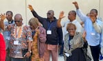 African delegates to the General Conference of the United Methodist Church pray outside the Charlotte Convention Center, in Charlotte, N.C., on May 2, 2024.