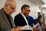 Vancouver City Council incumbent Erik Paulsen, center, reviews initial primary returns with councilors Bill Turlay and Bart Hansen.