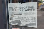 Signs in the window of a bar in downtown Graham, N.C.