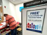 Flu and COVID-19 vaccinations are now available across the U.S., including at this CVS pharmacy in Palatine, Illinois.