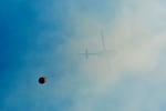 In this photo provided by the Bootleg Fire Incident Command, a helicopter is seen carrying a bucket on the Southeastern corner of the Bootleg fire, July 19, 2021