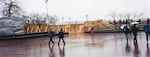 City crews and volunteers helped build a temporary wall along Tom McCall Waterfront Park in downtown Portland in 1996, to keep back flood waters.