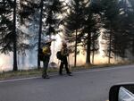 Firefighters working on the White River Fire in Wasco County, Ore., pause while walking on Forest Service Road 48 on Wednesday, Aug 26, 2020.