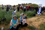 Protesters take part in a demonstration aimed at blocking trucks carrying humanitarian aid from entering Gaza, on the Israeli side of the Kerem Shalom border crossing with southern Gaza on Monday, Jan. 29.