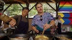 Saman Harnsongkram and his son Richard cook together at their booth, Bangkok Grill, at the Oregon Country Fair, July 14, 2024. 
