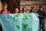 Portland students hold a sign during the Global Climate Strike in front of Portland City Hall.