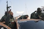 Syrian opposition fighters ride along the streets in the aftermath of the opposition's takeover of Hama, Syria, on Friday.