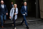Multnomah County Commissioner Julia Brim-Edwards, center, and Mayor Keith Wilson right, leave the federal courthouse in Portland, Ore. on Friday, Oct. 3. The state of Oregon and the city of Portland appeared in court Friday morning for a hearing on their motion to block President Trump's deployment of the National Guard.