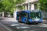 A TriMet bus drives through downtown Portland, Ore., June 29, 2024. TriMet plans to add 10 electric buses to the fleet, as a step toward addressing long-standing disparities in transportation service along 82nd Avenue, an especially diverse and low-income area.