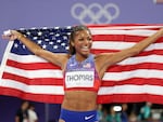 Sprinter Gabby Thomas of the U.S. celebrates winning the gold medal after competing in the women's 200m final on Tuesday at the Paris Olympic Games at Stade de France.