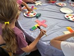 Campers at Mt. Olive Lutheran Church in Santa Monica, Calif., paint crosses during craft time at vacation Bible school.