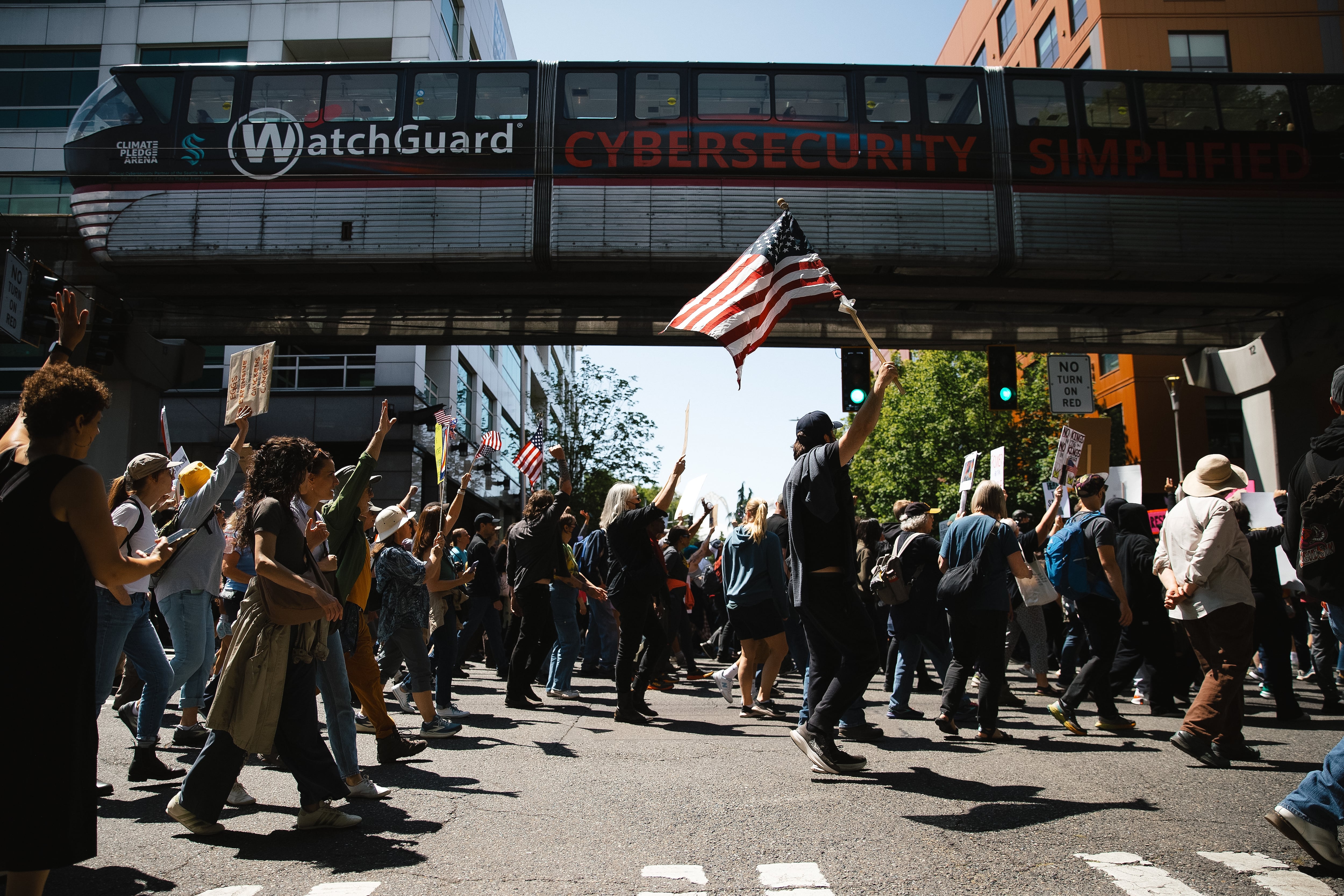 Seattle: Demonstrators cheer after getting a horn from the Seattle Monorail while marching from Cal Anderson Park to Seattle Center.