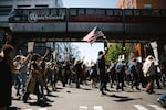 Seattle: Demonstrators cheer after getting a horn from the Seattle Monorail while marching from Cal Anderson Park to Seattle Center.