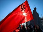 Russian Communist supporters hold flags including one of the Soviet Union, as they take part in a rally next to the Karl Marx monument, marking the "Defender of the Fatherland Day," the former "Day of the Soviet Army", in downtown Moscow on Feb. 23.