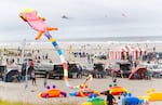Kites fly in the air while dozens of participants relax on the beach during the Washington State International Kite Festival in Long Beach, Wash., on Aug. 22, 2026. The Long Beach Peninsula is known for its continuous 28-mile beach.