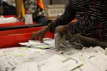 A Multnomah County elections worker sorts ballots.