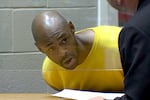 In this screenshot from video, Tony Latrell Williams talks with an attorney as Williams is arraigned in the Marion County Circuit Court in Salem, Ore., June 2, 2025.