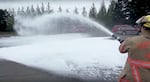 Portland firefighters spray foam at a training site in Northeast Portland as a demonstration in 2014. This foam is crucial for fighting intense fires like those from an airplane or oil train. But it also contains harmful chemicals that have seeped into groundwater.