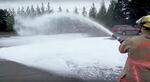 Portland firefighters spray foam at a training site in Northeast Portland as a demonstration in 2014. This foam is crucial for fighting intense fires like those from an airplane or oil train. But it also contains harmful chemicals that have seeped into groundwater.