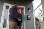 FILE - Kate and Quantas Ginn pose for a photo Sunday, Dec. 29, 2019 at their home in Tacoma, Wash. Kate Ginn, who was expecting a baby, planned to apply for paid time off from her job as a project manager for a non-profit organization under Washington state's new paid family leave law.