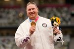 Gold medalist Ryan Crouser, of the United States, poses during the medal ceremony for the men's shot put at the 2020 Summer Olympics, Thursday, Aug. 5, 2021, in Tokyo.