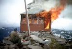 East Zigzag Lookout being burned by a Forest Service ranger in 1965. Many of the historic lookout towers were intentionally burned by the Forest Service.