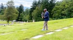 Engedaw Berhanu visits his nephew Mulugeta Seraw’s gravesite in Portland, Ore. on May 29, 2024.