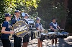 The George Fox University drummers play outside of dorms.