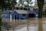 A flooded home is seen from the banks of the Ohio River on Saturday in Louisville, Ky.