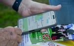 A man looks at a map on his cell phone.