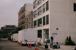 Asylum-seekers spill out onto Hall Street outside the Clinton Hill Shelter. Two shower units stand outside at 47 Hall St. in Brooklyn on July 19.