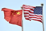 Chinese and US flags wave outside a technology company in Beijing, on April 17, 2025. China told Washington on April 16 to "stop threatening and blackmailing" after US President Donald Trump said it was up to Beijing to come to the negotiating table to discuss ending their trade war. Trump has slapped new tariffs on friend and foe but has reserved his heaviest blows for China, with 145 percent on many Chinese imports even as Beijing has retaliated with levies on US goods of 125 percent. (Photo by Pedro Pardo / AFP) (Photo by PEDRO PARDO/AFP via Getty Images)