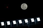 The second supermoon of 2023, also known as the sturgeon supermoon, rises before the start of the Copa Libertadores soccer match at the Mas Monumental stadium in Buenos Aires on Tuesday.