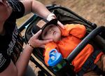 Grainger Peterson protects his ears with the help of his mom during the chainsaw competition events.