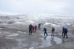 A group of scientists from the United Kingdom trek up to a research site on the west side of the Greenland ice sheet near Kangerlussuaq in the summer of 2022. This year marks the 26th year that Greenland has lost more ice than it gained.