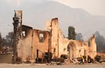 A man walks past the charred remains of the Altadena Community Church, Thursday, Jan. 9, 2025, in the Altadena section of Pasadena, Calif.