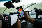 A scientist looks at radar on his phone while tracking a supercell thunderstorm in Oklahoma. 