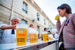 A woman drinks an alcohol-free beer during the annual "Fete de la Musique" (music day), in the courtyard of the Elysee Palace in Paris in 2018.