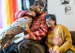 Marcieline Novatore, center, and her partner Eloise Zana, with their dog “Bow,” in their Northwest Portland home, Jan. 22, 2024. Novatore and Zana, both in their mid-20s, each experienced homlessness in Portland. Oregon has the highest rate of unaccompanied, unsheltered youth in the nation.