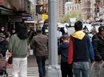 People walking through a busy street in Chinatown in New York City. About 11 percent of Chinese Americans live in poverty, according to a new analysis by the Pew Research Center.