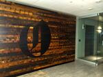 The Oregonian reports that the "O" logo was burned into a reclaimed wood wall with a torch.